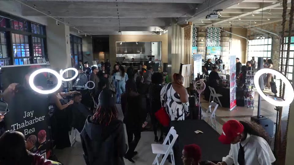 Guests connecting around live barbering demonstrations at The Art of Barbering VA.