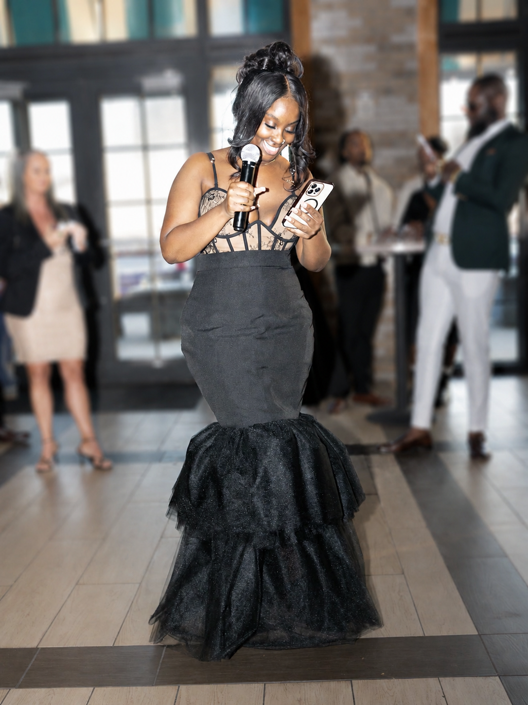 Bria Riddick speaking at a black tie event.